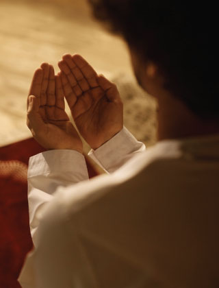 Person making dua with raised hands